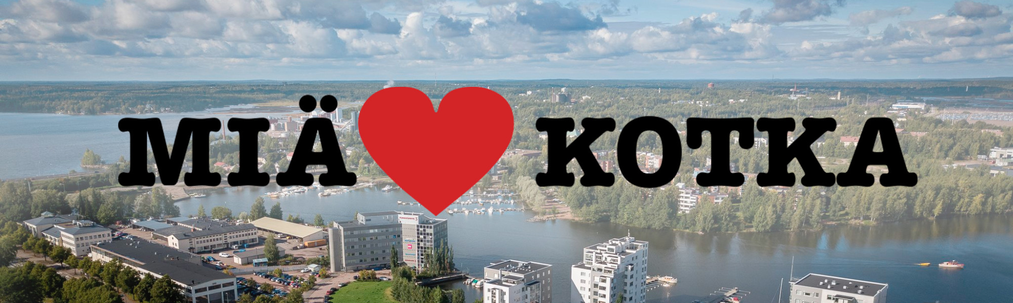 Kuvassa on ilmakuva Kotkasta ja Miä sydän Kotka-logo